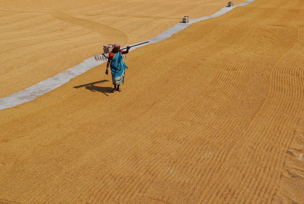 a person walking across a field with a baseball bat