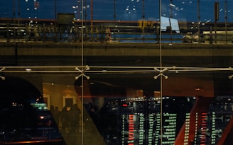 a reflection of a clock in a glass window