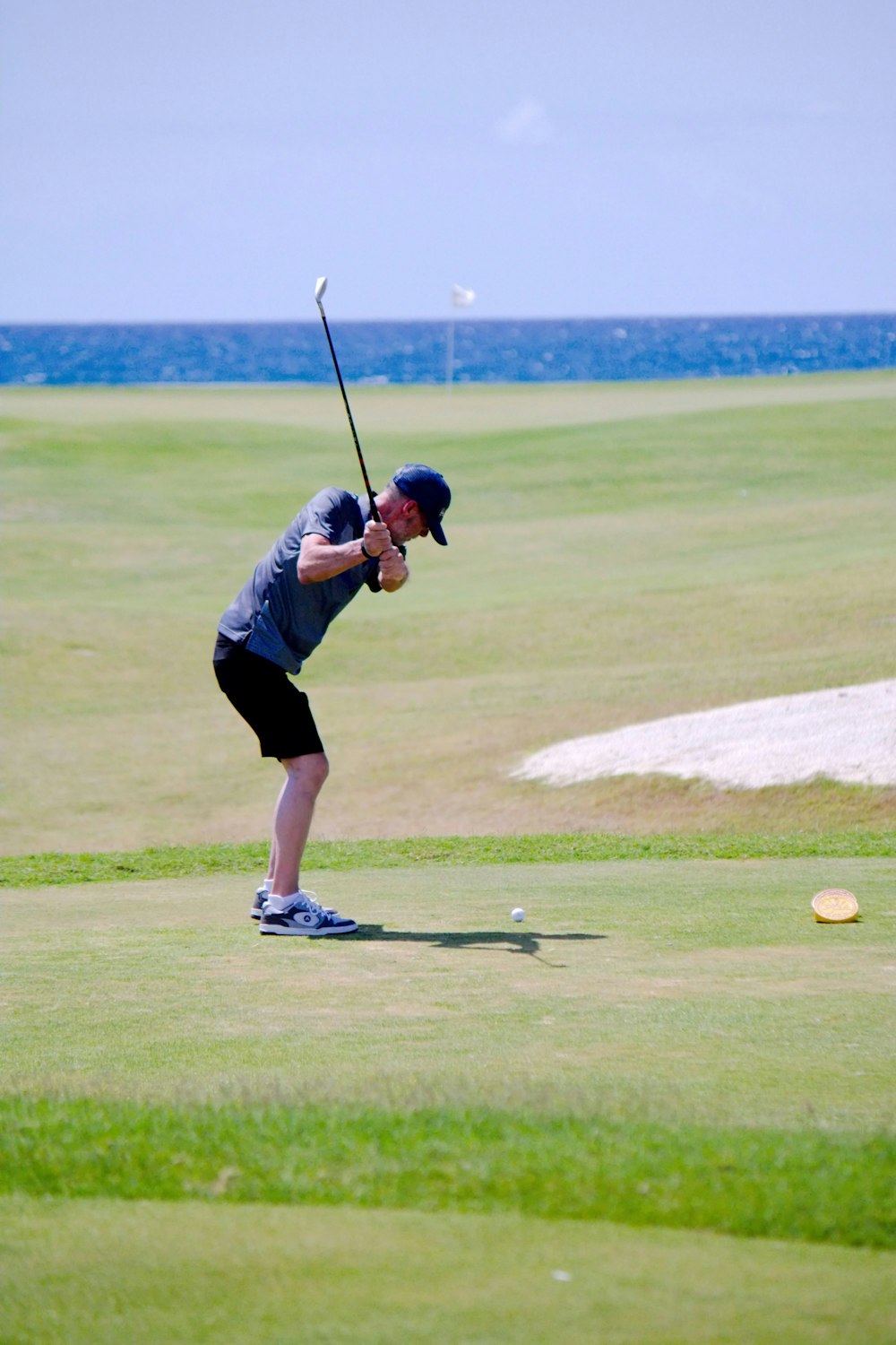 a man swinging a golf club on a golf course