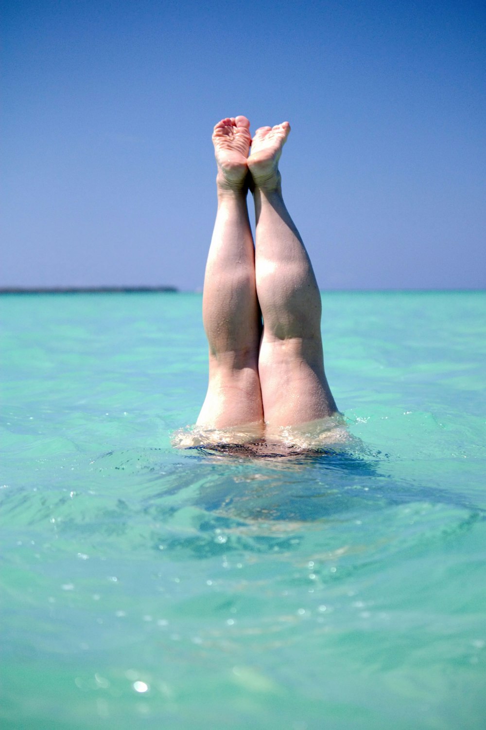 a person laying on their back in the water