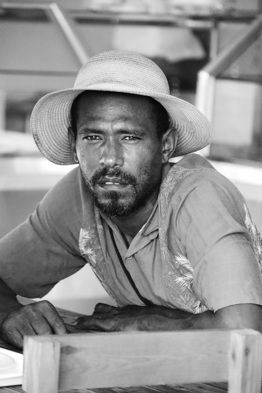 a black and white photo of a man wearing a hat