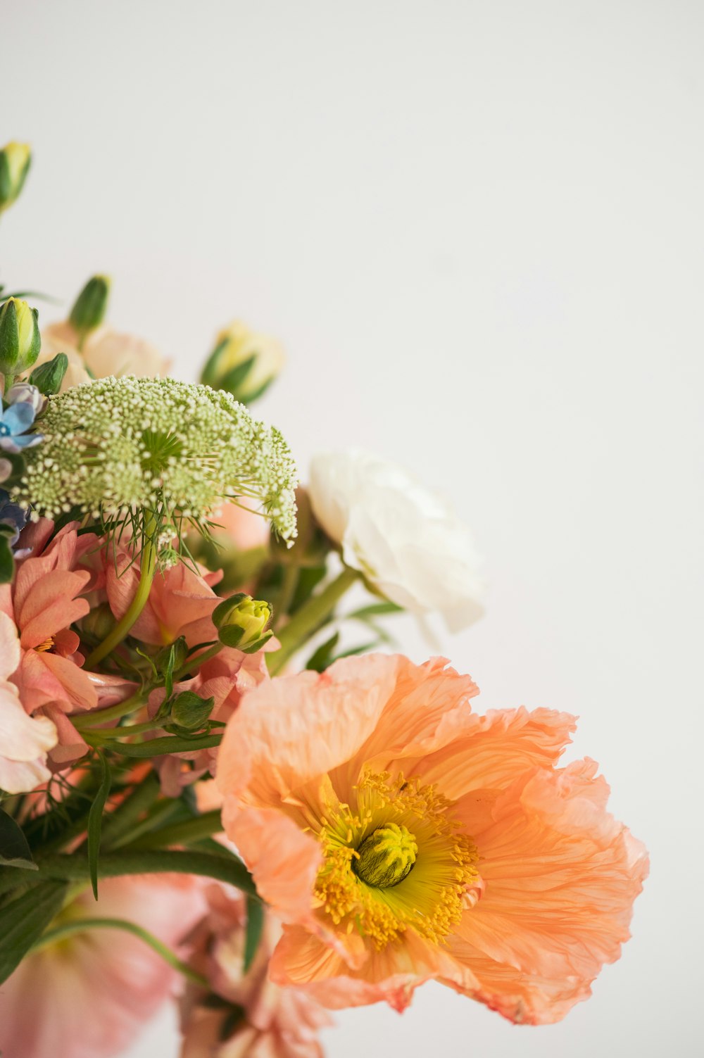 a vase filled with lots of different colored flowers