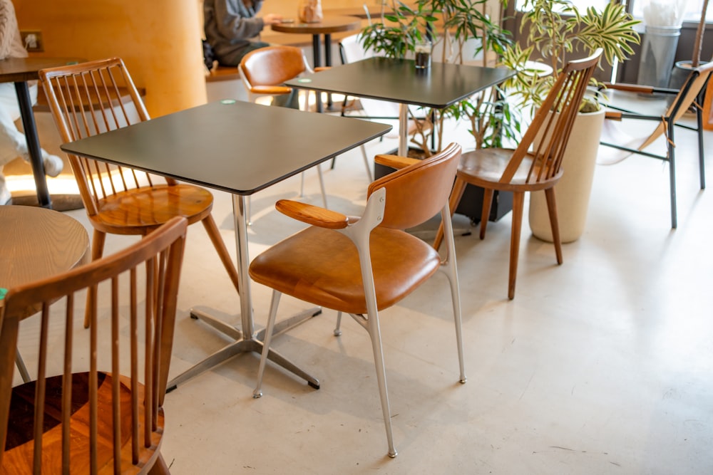 a restaurant with tables and chairs and a potted plant