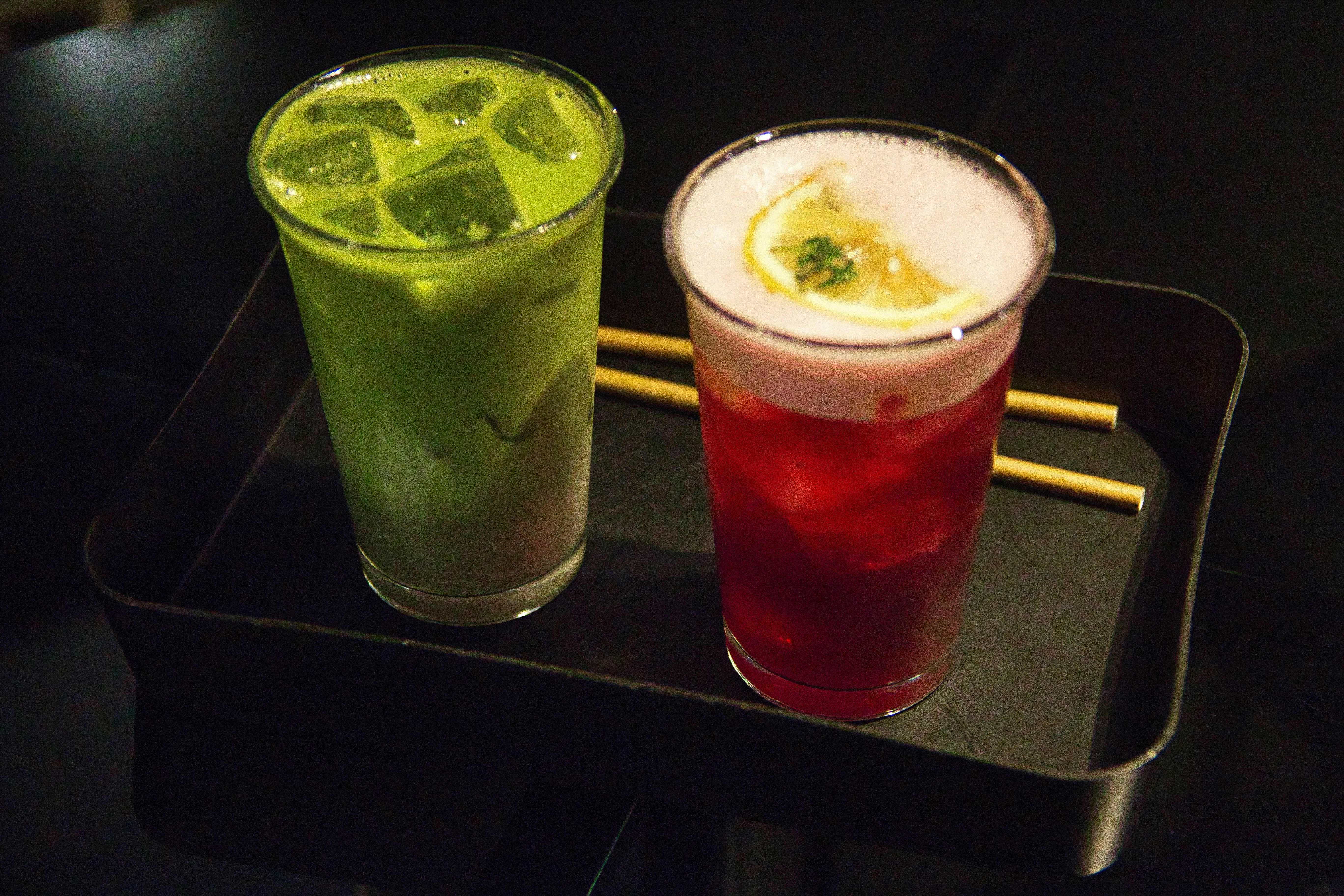 two drinks are sitting on a tray on a table