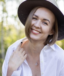 a woman wearing a hat and a white shirt