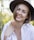 a woman wearing a hat and a white shirt