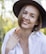 a woman wearing a hat and a white shirt
