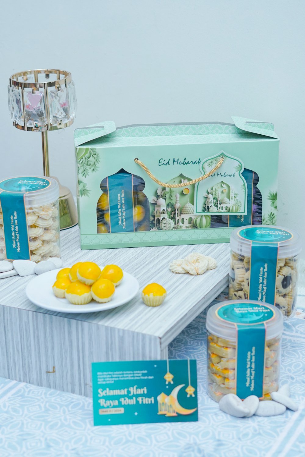 a table topped with a box of cookies and oranges