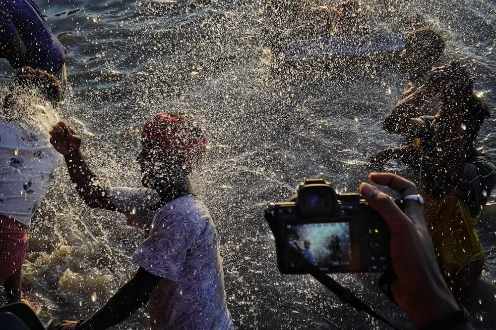 a group of people splashing in the water