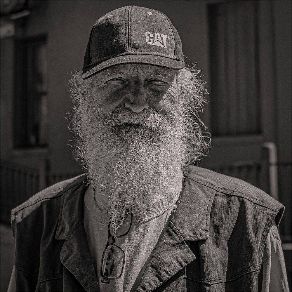 a black and white photo of a man wearing a hat