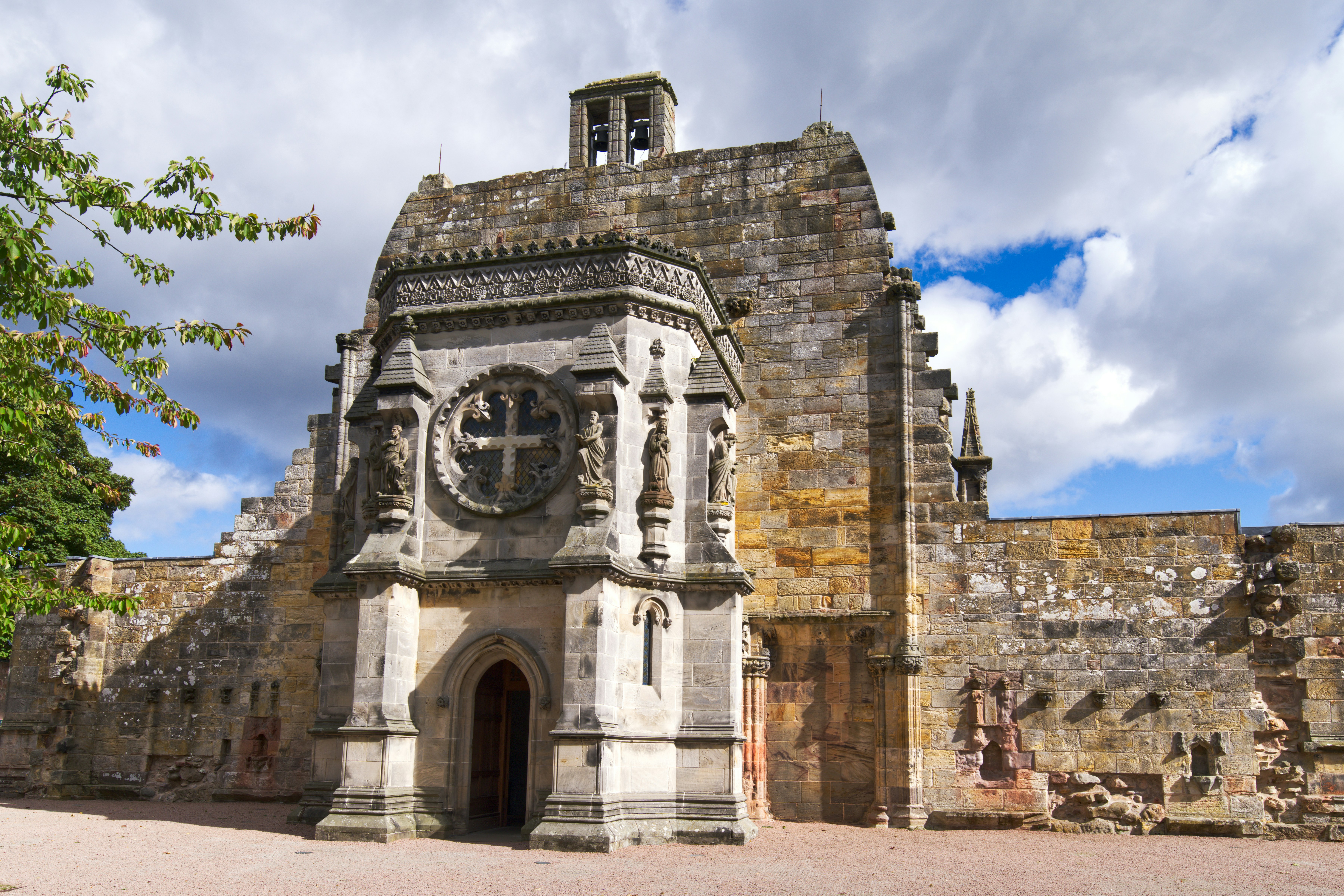 a stone building with a clock on the front of it