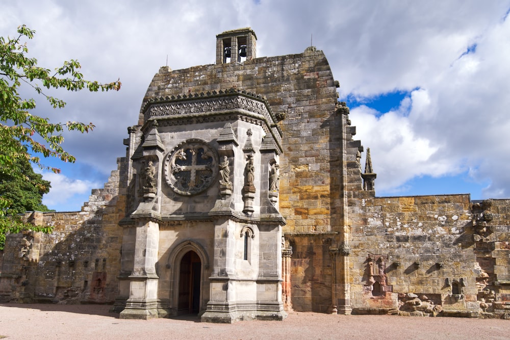 a stone building with a clock on the front of it