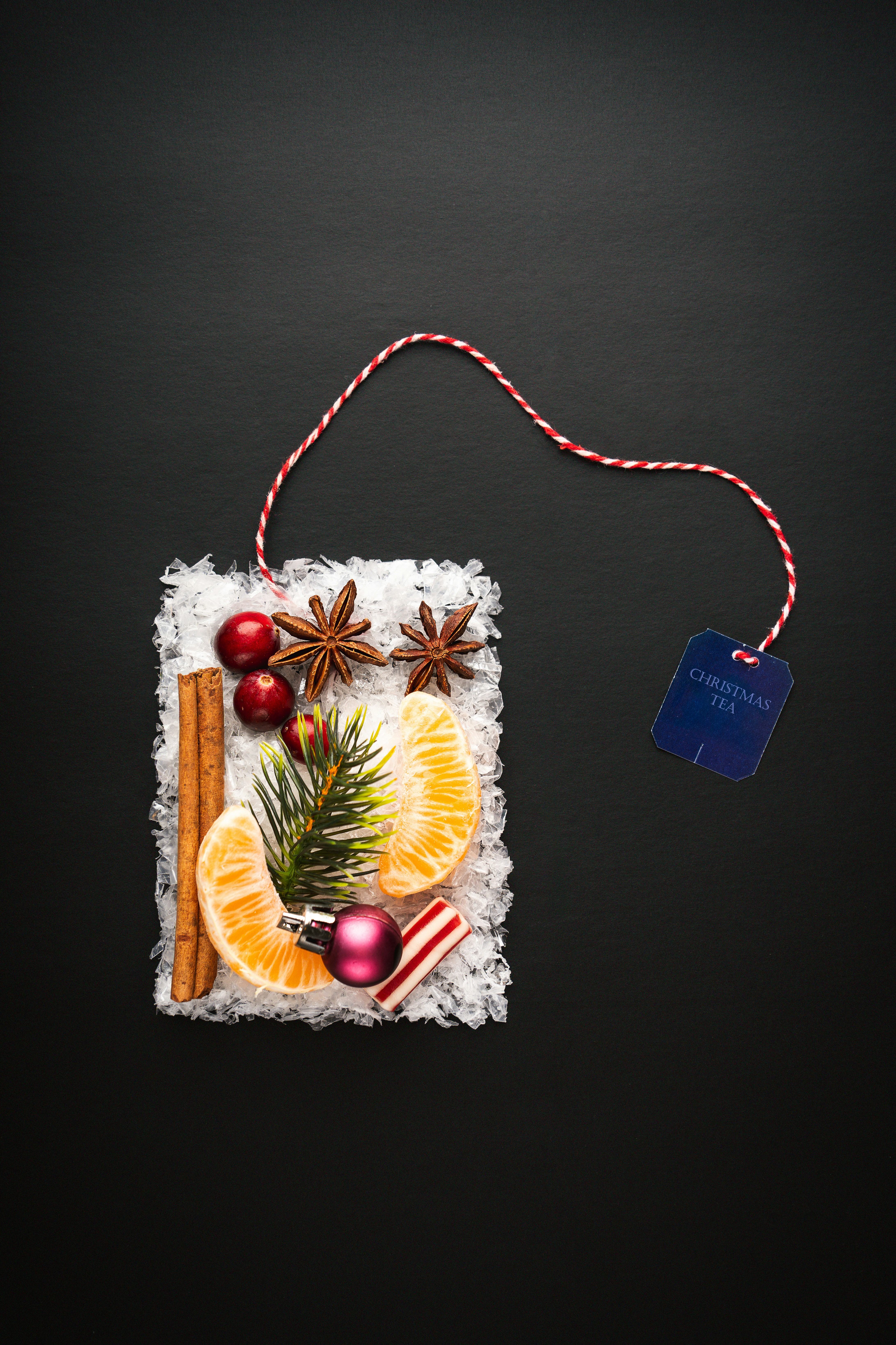 a christmas ornament with an orange, cinnamon, star anise, and