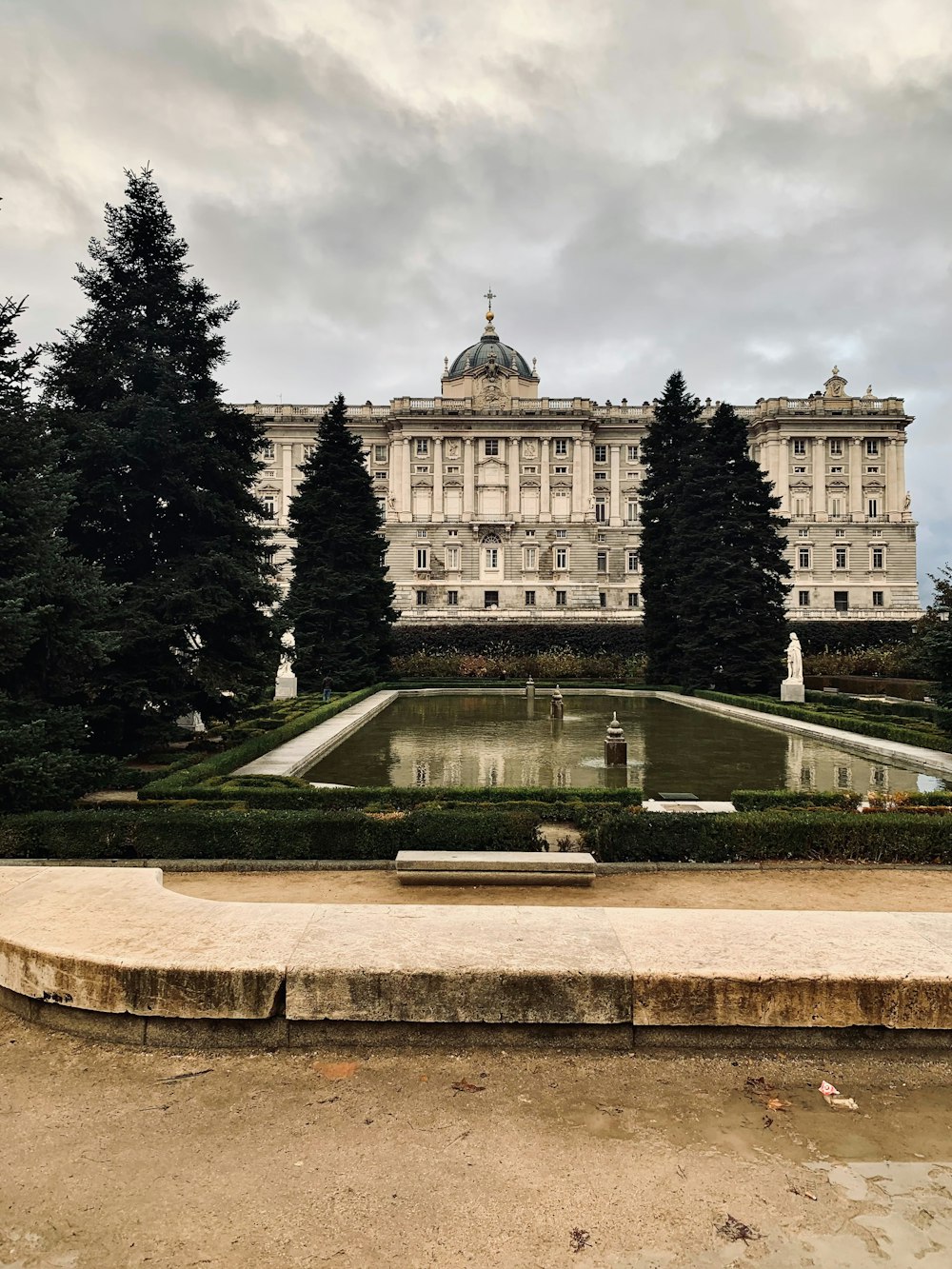 a large building with a fountain in front of it