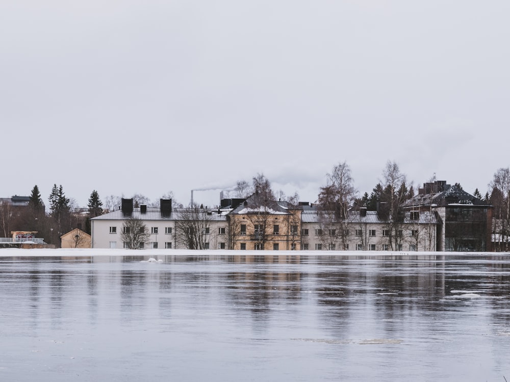 a large body of water with buildings in the background