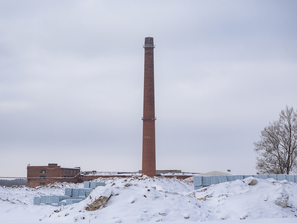 a tall brick building sitting on top of a snow covered field