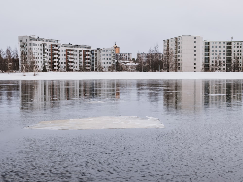 a large body of water with buildings in the background