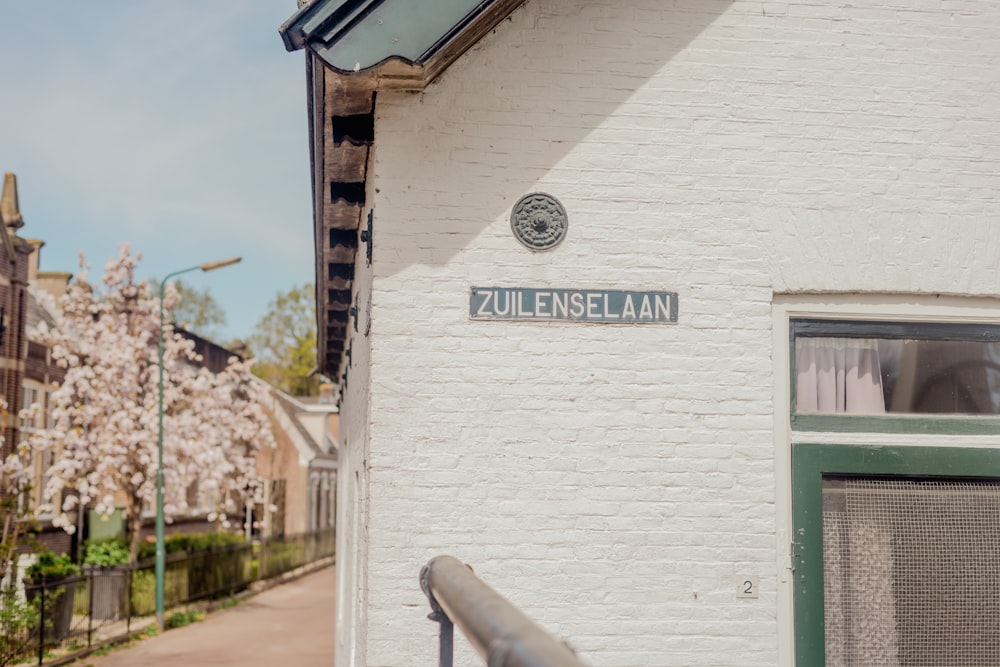 a white building with a sign on the side of it