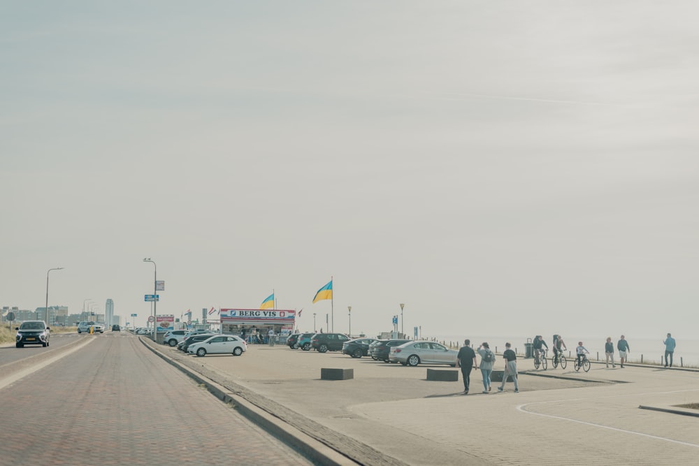 a group of people standing on the side of a road