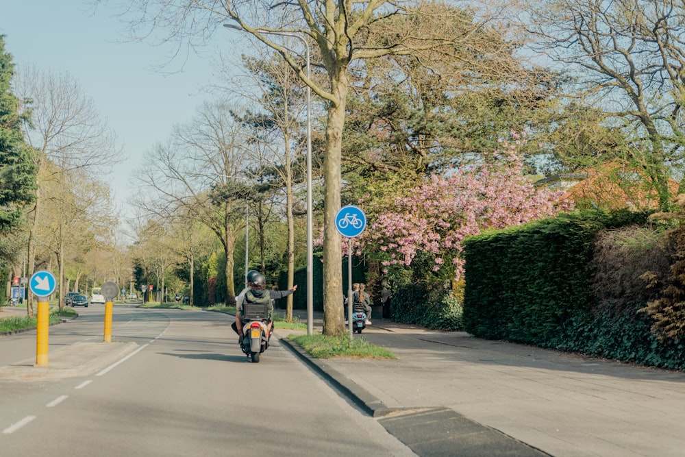 a person riding a motorcycle down a street