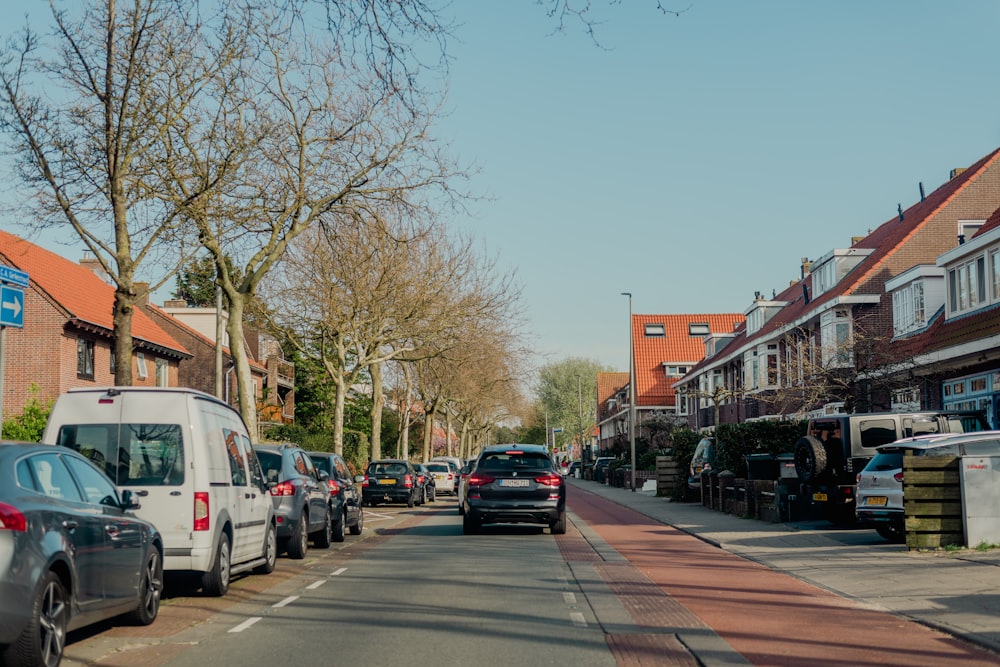 a street lined with parked cars next to tall buildings