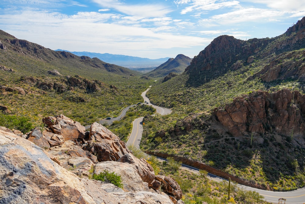 a scenic view of a winding road in the mountains