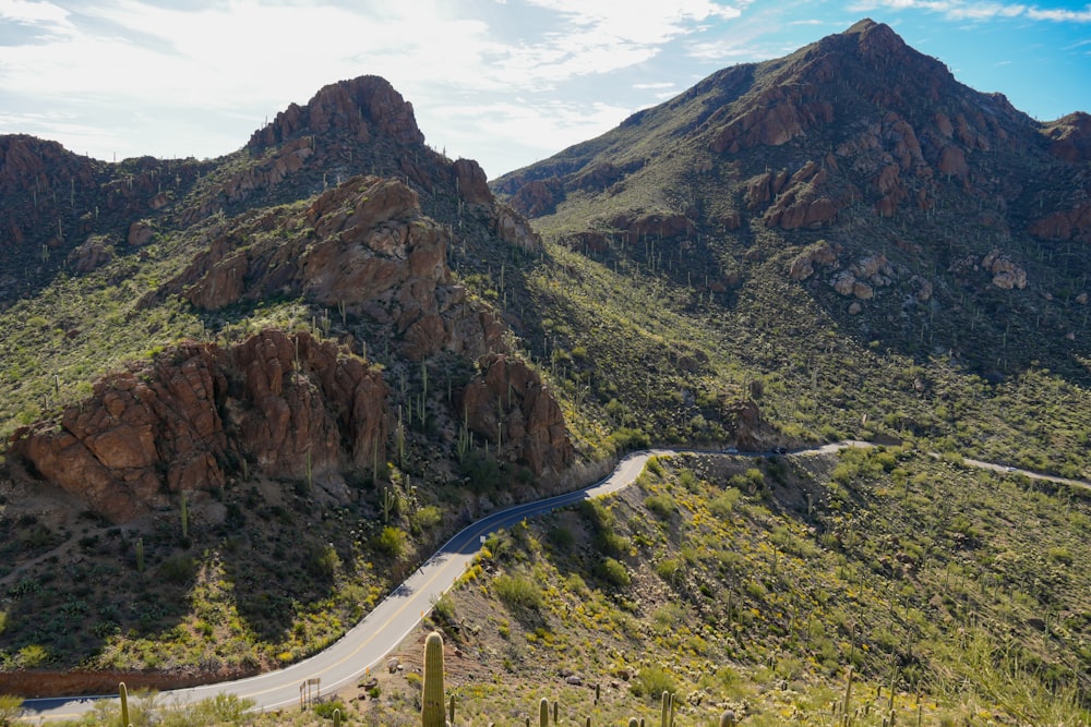 a winding road in the middle of a mountain range