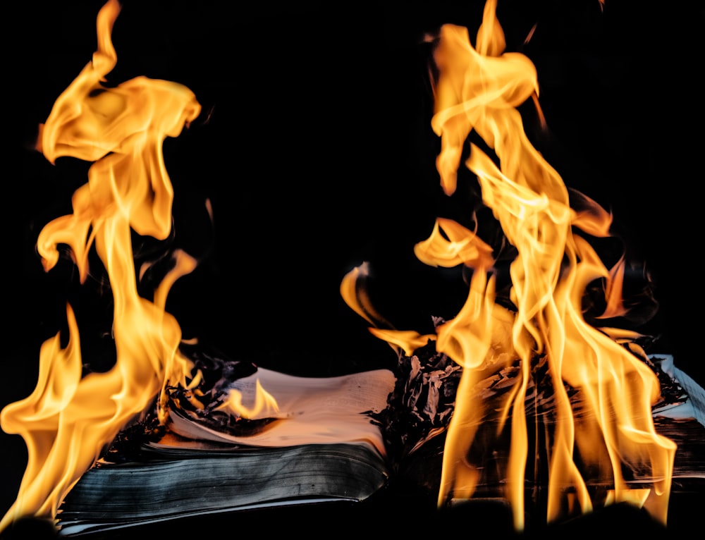 a book on fire on a black background