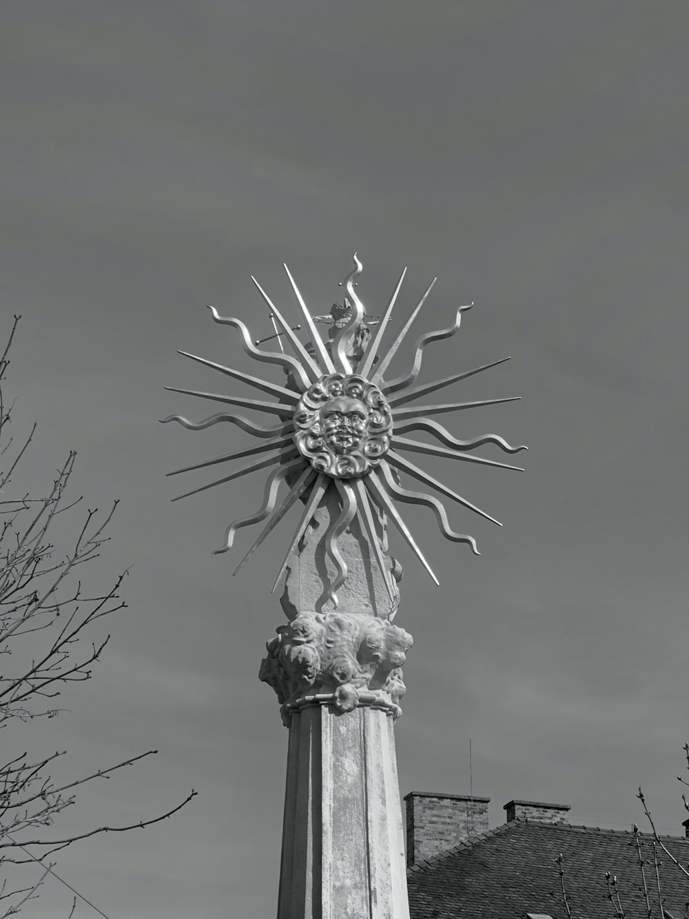 a large metal sun on top of a building