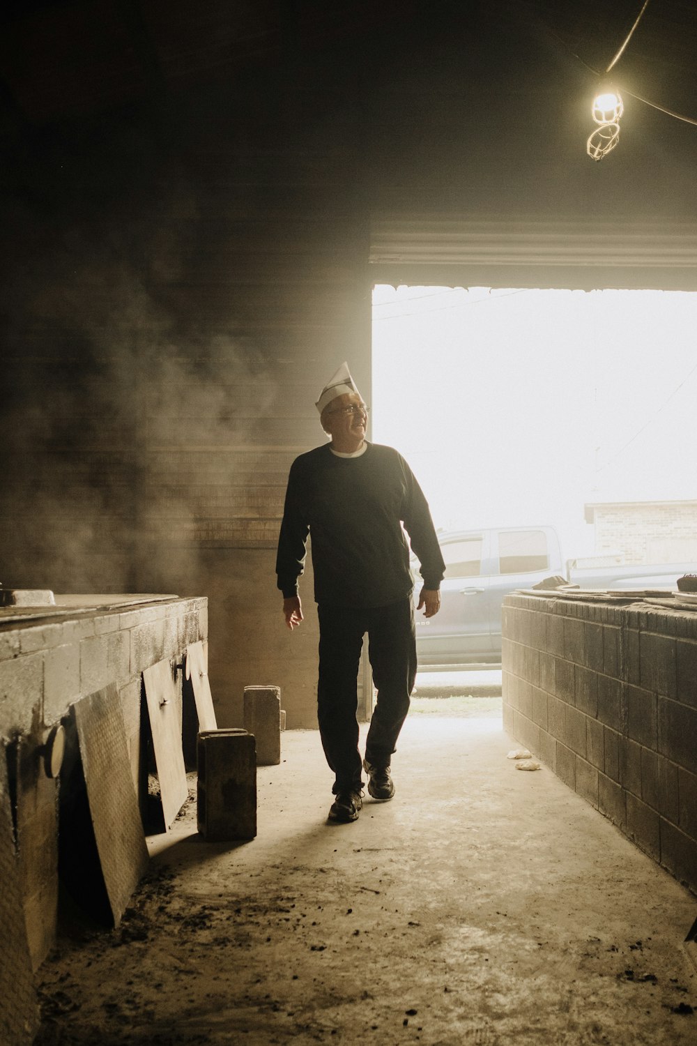 a man walking down a hallway in a building