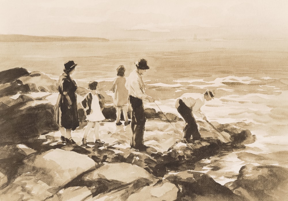 a group of people standing on top of a rocky beach