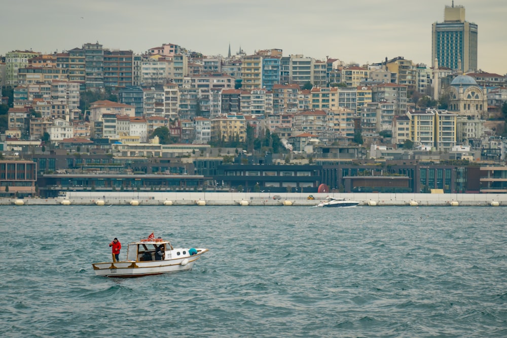 a boat in the water with a city in the background