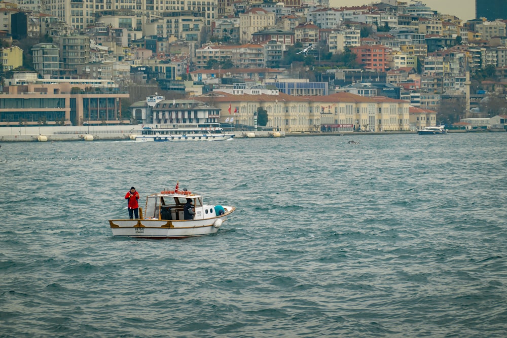 a boat in the water with a city in the background