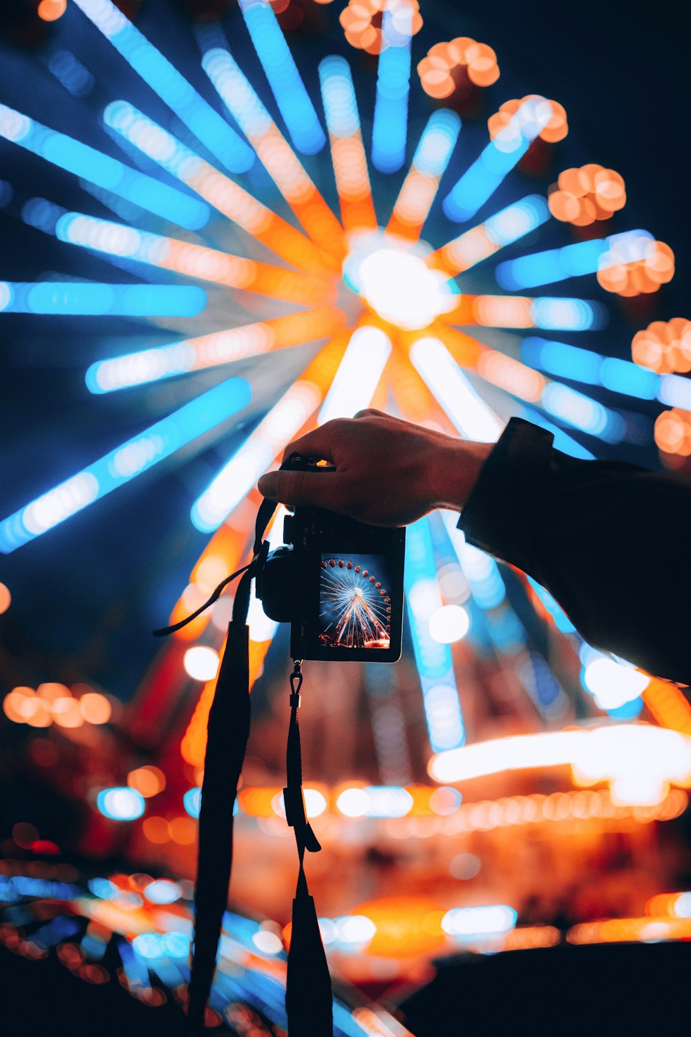 a person taking a picture of a fireworks display
