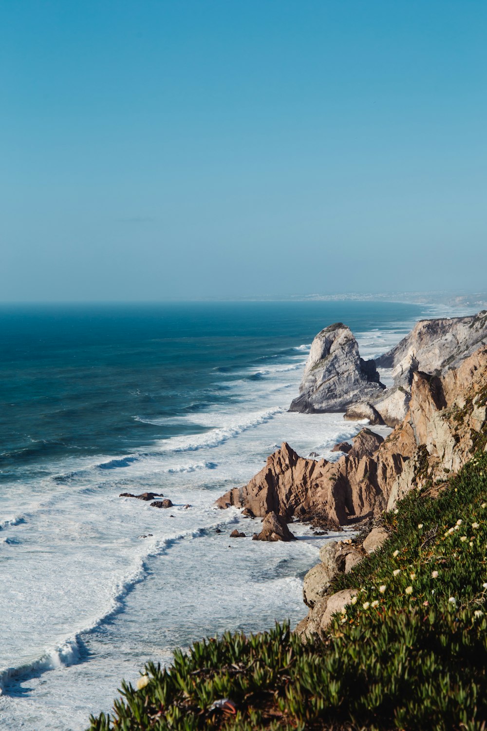 a view of the ocean from the top of a hill