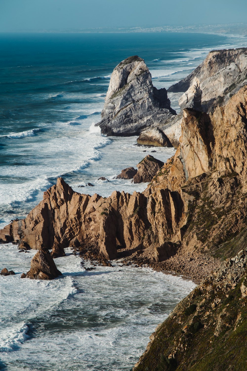 a view of the ocean from the top of a hill