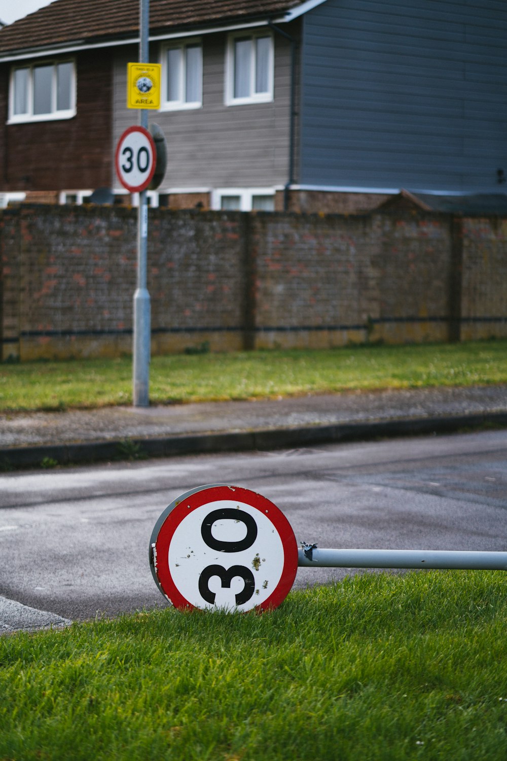 a red and white sign sitting on the side of a road