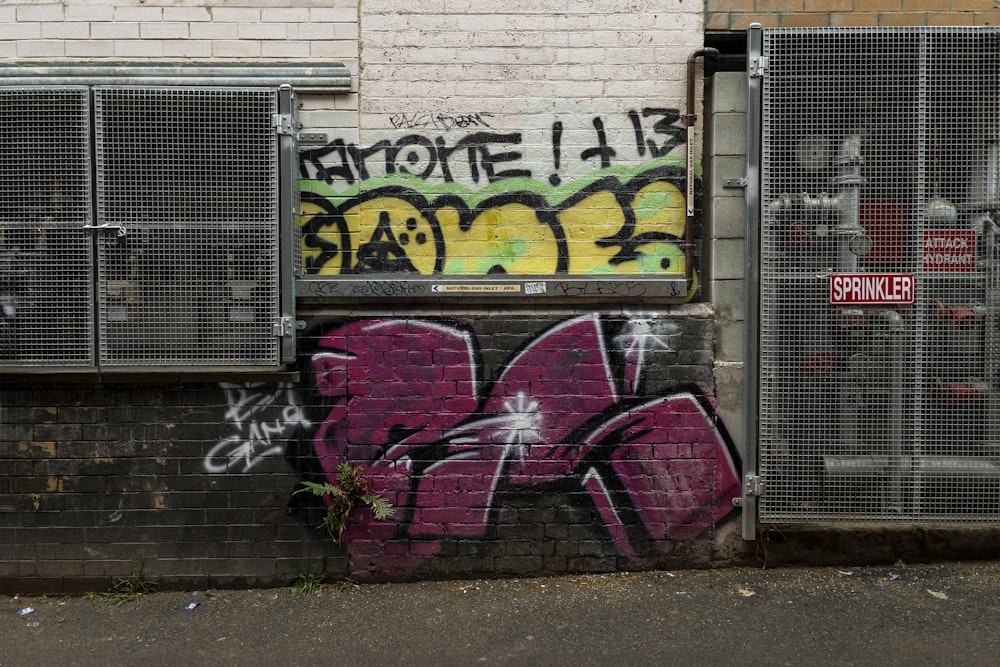 a brick building with graffiti on the side of it