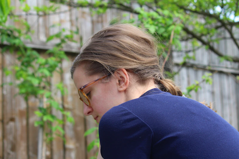 woman in a blue shirt checking her phone