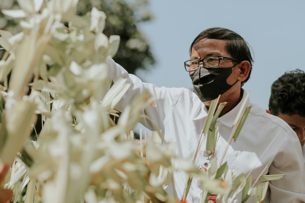 a man wearing a black mask and glasses