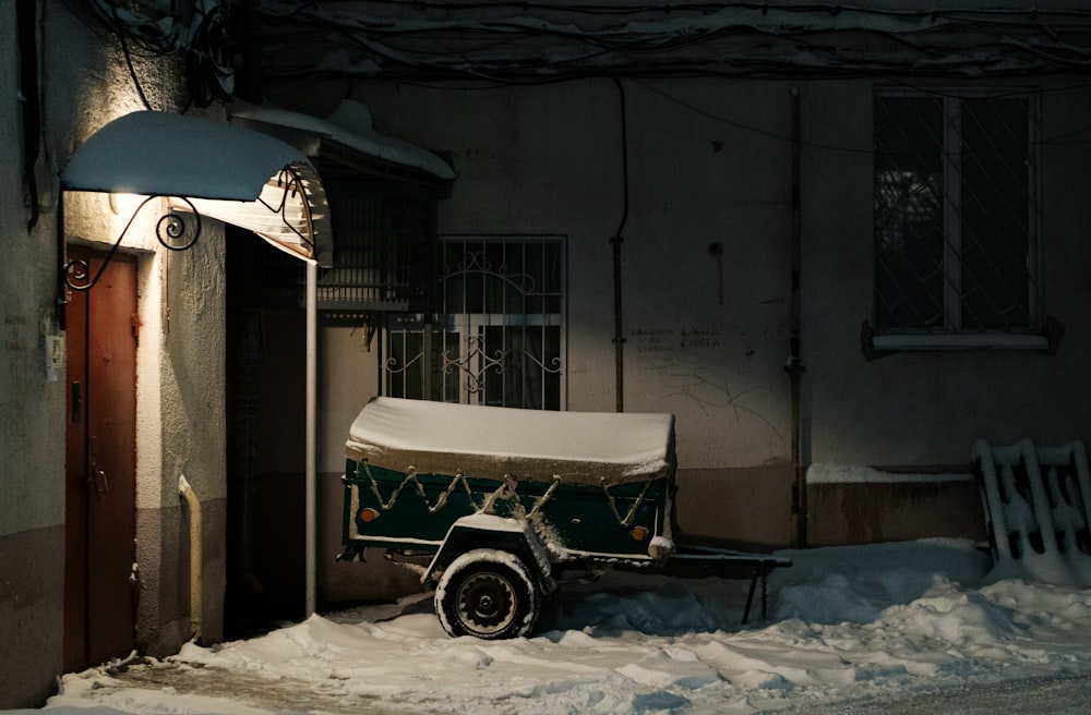 a covered cart sitting in the middle of a snow covered street