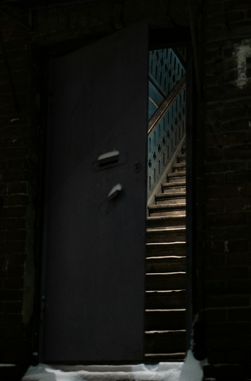 an open door with a stair case in the background