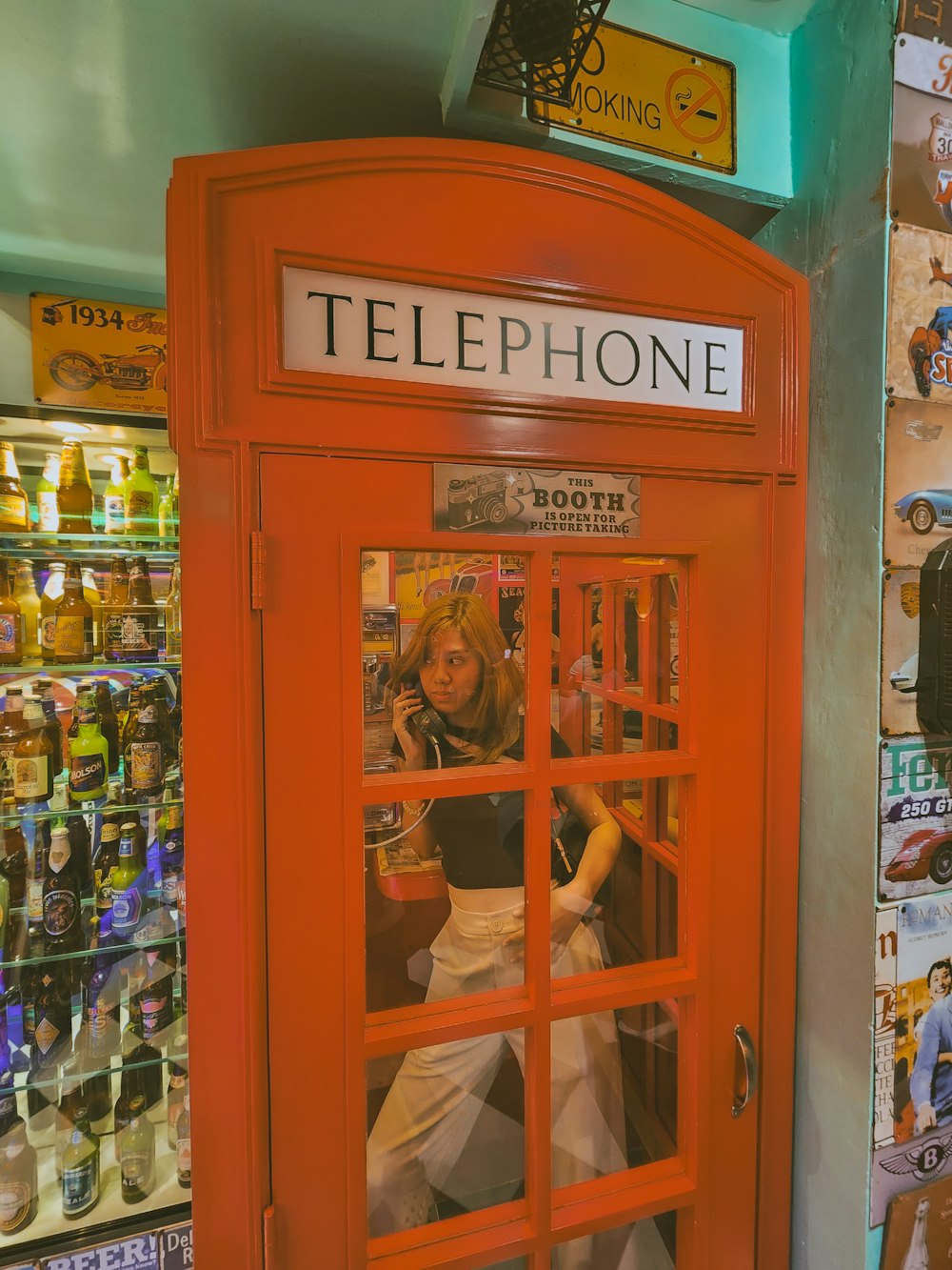 a woman in a phone booth in a store
