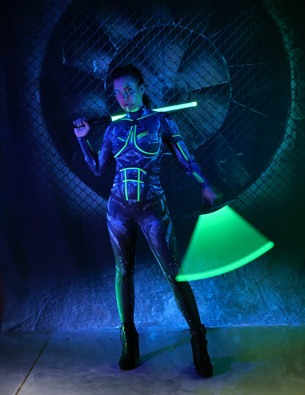 a woman holding a neon green frisbee in a dark room