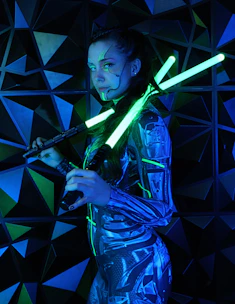 a woman holding two lightsabes in her hands