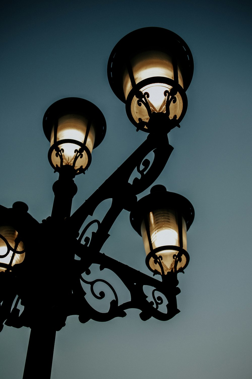 a street light with three lights on each of it