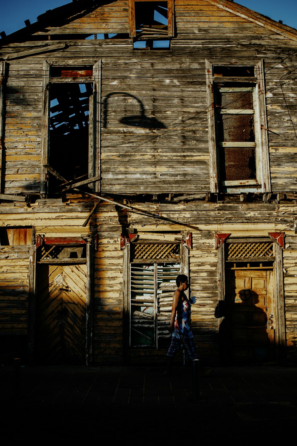 a person standing in front of a run down building