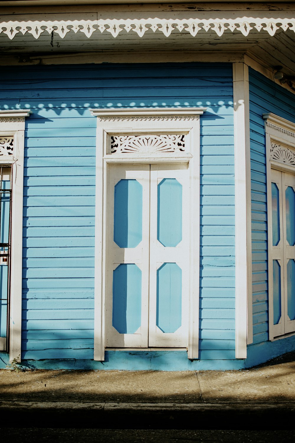 a blue house with white trim and windows