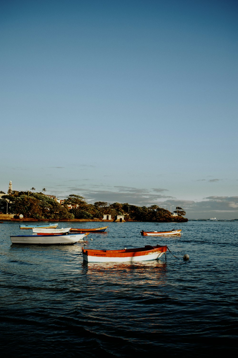 a group of boats floating on top of a body of water