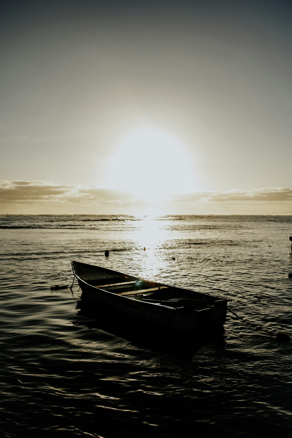 a small boat floating on top of a body of water